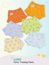 Six patterned LUNO potty training pants displayed in a flat lay featuring fox, giraffe, avocado, and rainbow prints