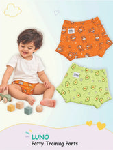 Baby in orange LUNO potty training pants next to puppy and avocado print pairs.