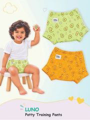 Child in avocado-print LUNO potty training pants on a stool next to flat-lay Giraffe and Avocado pairs.