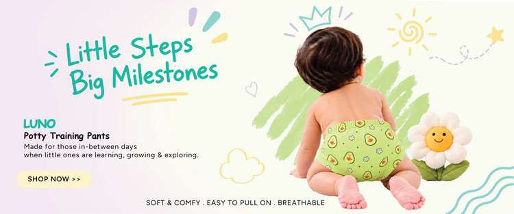 Baby crawling in avocado print LUNO potty training pants under Little Steps Big Milestones text banner
